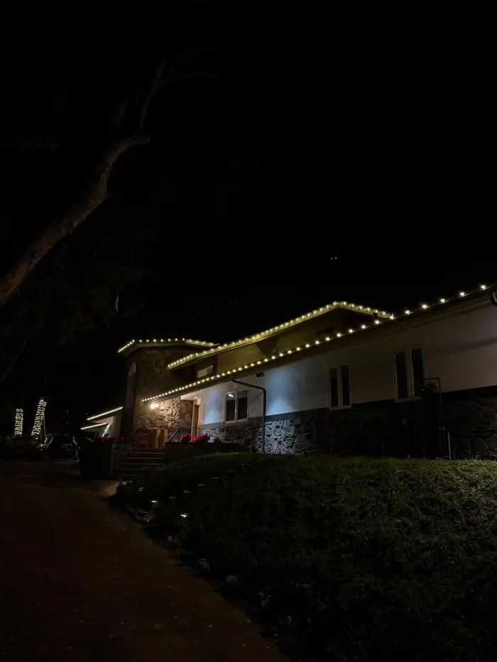 Hillside home with roofline lights