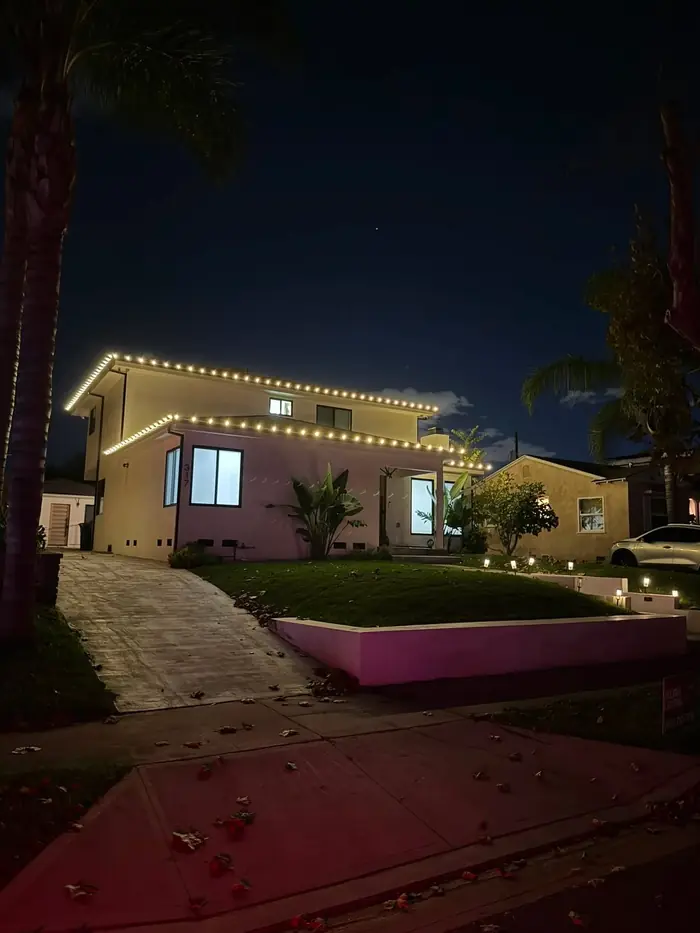 Two-story home with crisp warm white roofline lighting